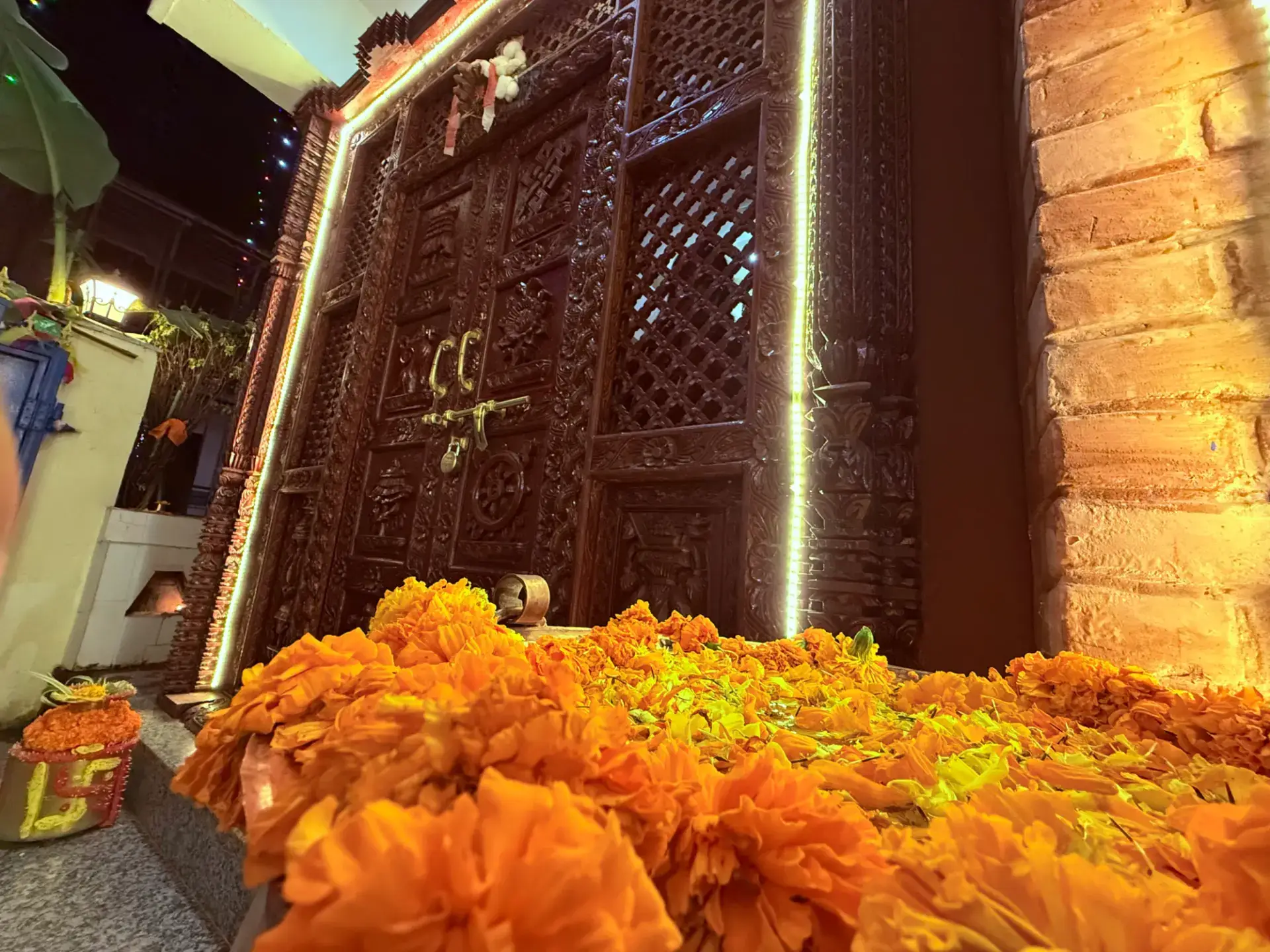 Marigold garlands at the carved wooden doorway during the Tihar festival
