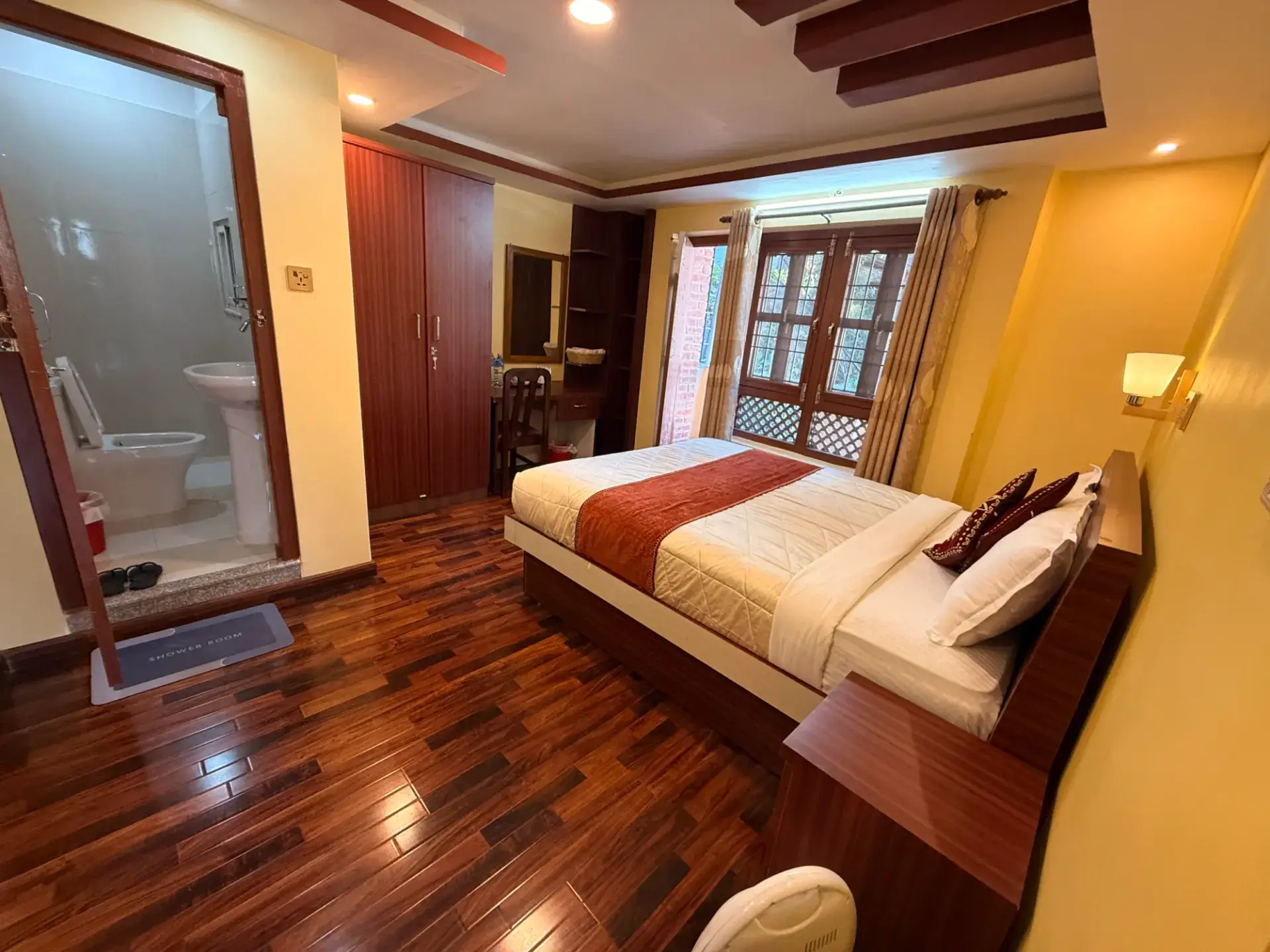 Deluxe King Room with king bed, wooden floor and en-suite bathroom
