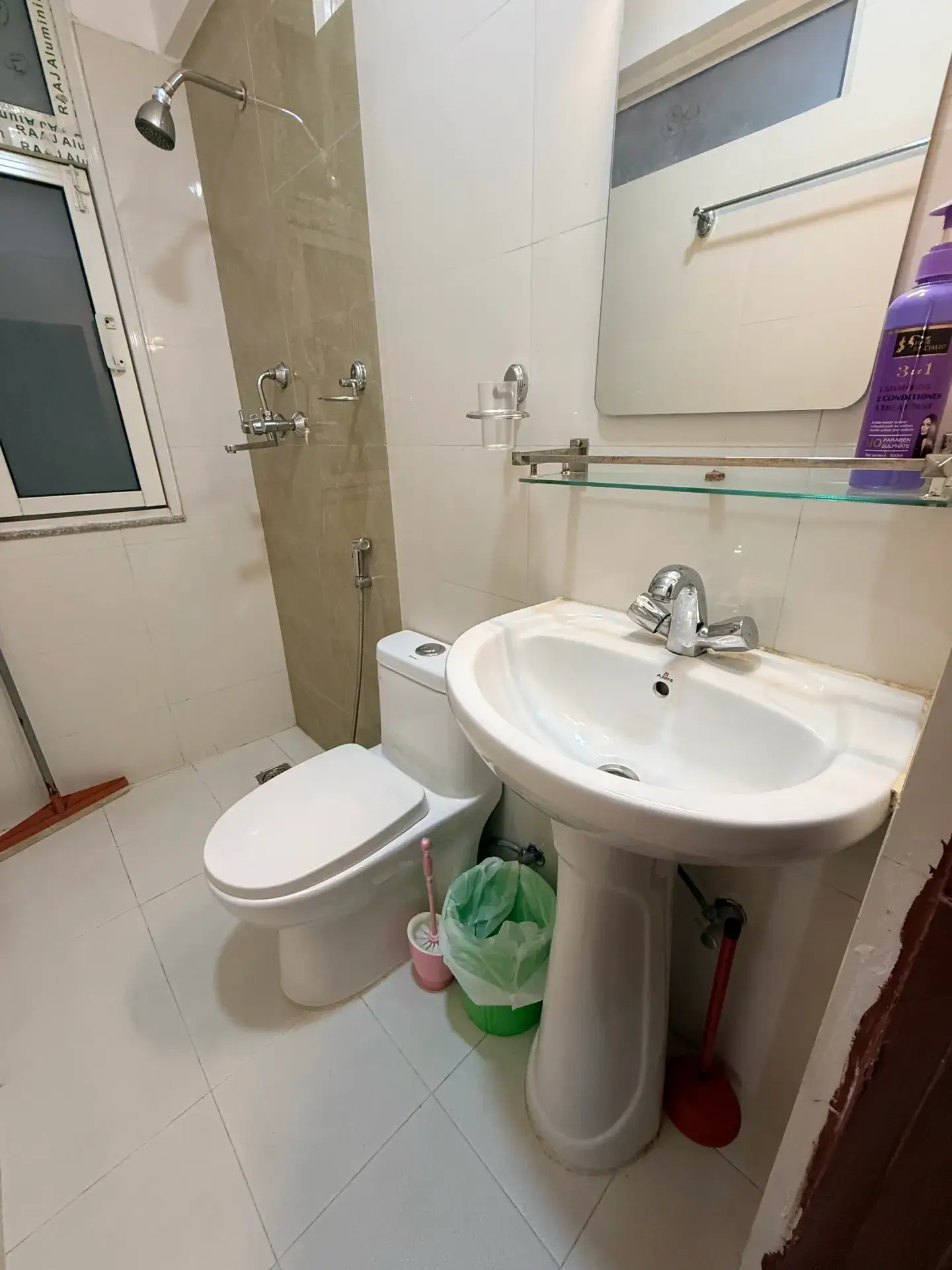 Apartment bathroom with shower, basin and window