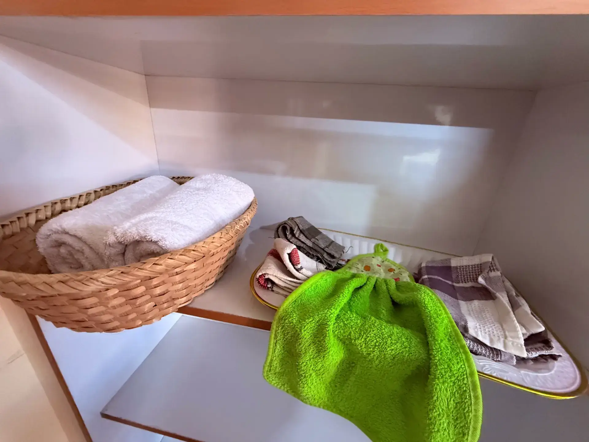 Fresh rolled towels and toiletries in a woven basket