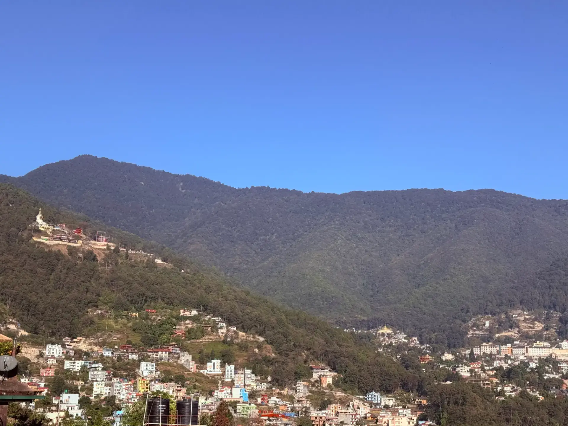 Daytime view of Shivapuri forest and the Budhanilkantha neighbourhood from the terrace