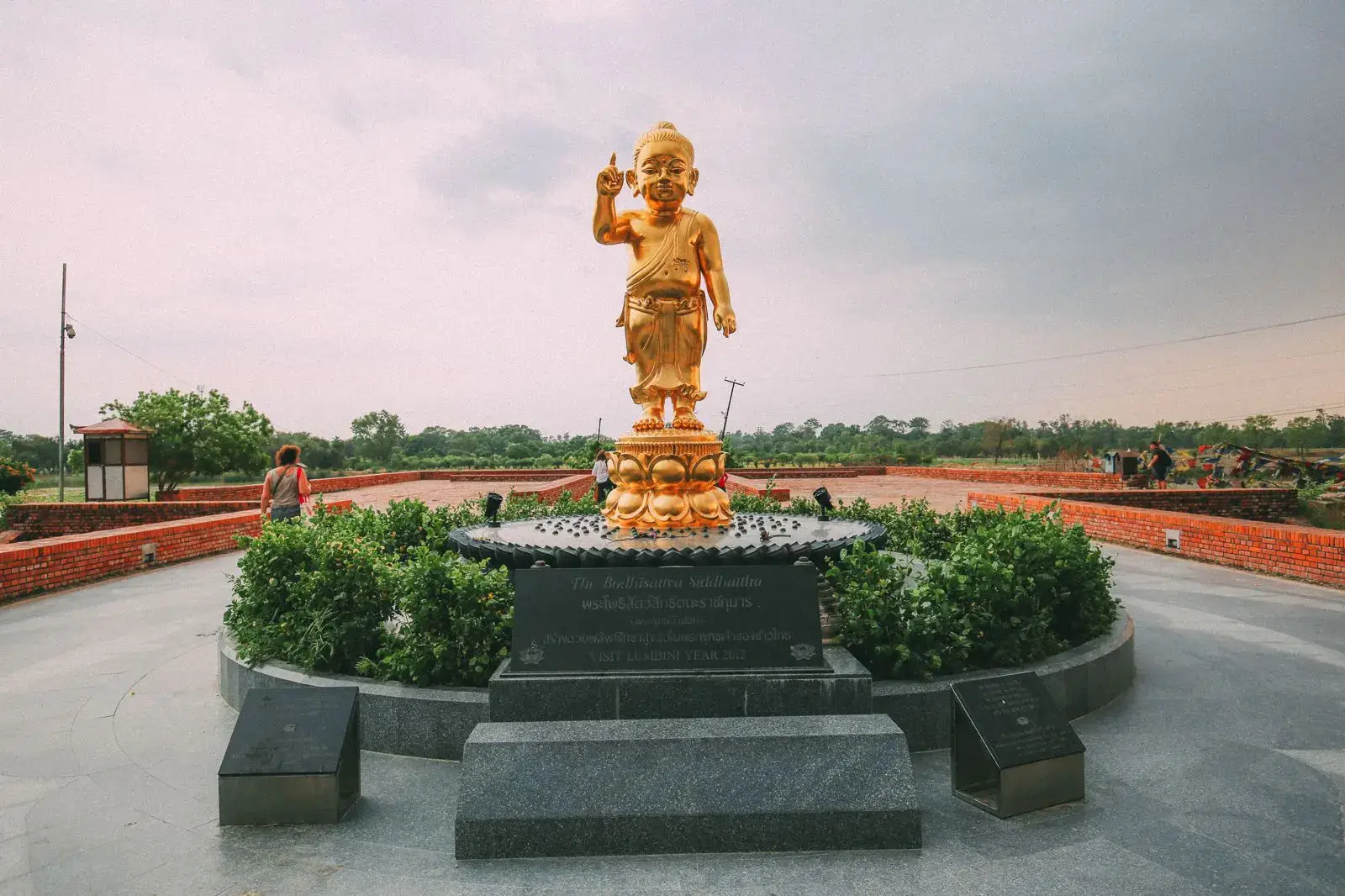 Golden statue of the infant Buddha in the Lumbini Sacred Garden