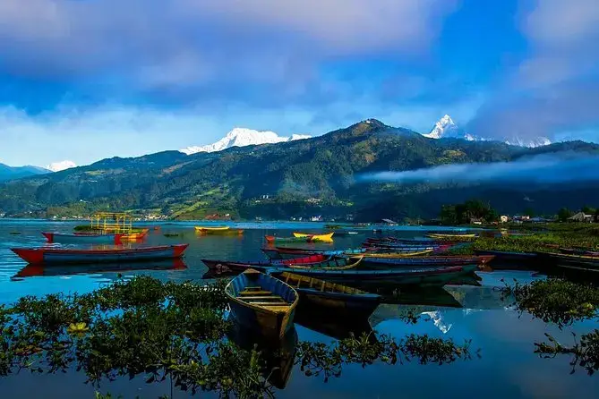 Colourful boats on Phewa Lake in Pokhara with Machapuchare behind